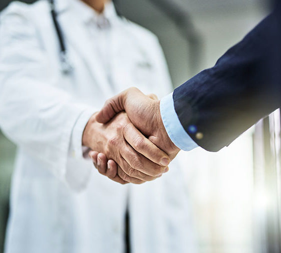 A person shaking hands with a medical professional.